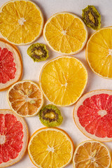 Creative food fruit texture with dried grapefruit, orange, kiwi and lemon on white background, top view