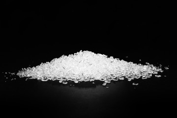 Transparent polypropylene granules plastic pellets material on black background