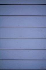 Fototapeta premium here are some horizontal blue gray wooden siding panels that have been worn by weathering