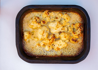 A metal dish of cauliflower cheese
