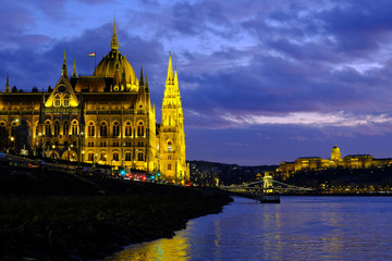 Fototapeta na wymiar Panoramic view on illuminated Budapest parliament on Danube river, Chain bridge and Buda castle at night