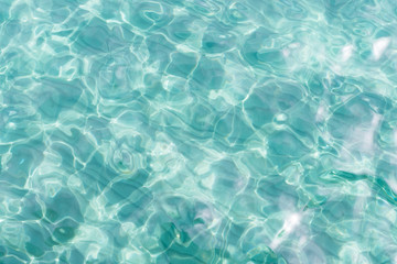 Fototapeta na wymiar Top view close up of a sea water surface with small shiny ripples