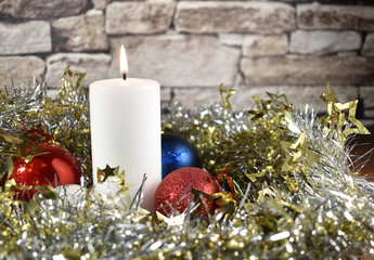 Christmas  candles with silver tinsel and ornaments