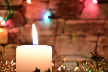 Christmas  candles with silver tinsel and ornaments 