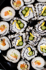 sushi roll viewed from above with different ingredients and with sesame seeds. sushi pattern with white rice. background for sushi japanese food