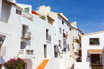 A town north of Alicante on the Mediterranean coast on a sunny morning, Altea, Spain. A scenic street corner with picturesque buildings painted in white.