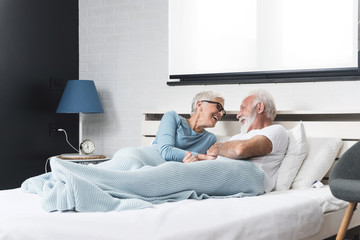 Senior couple lying in bed together