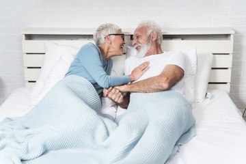 Senior couple lying in bed together