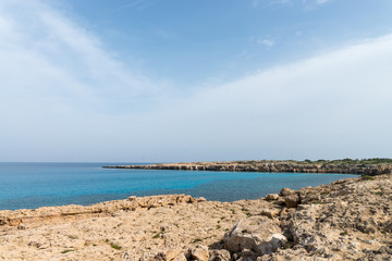 Curved rocky seashore and transparent water of Mediterranean sea