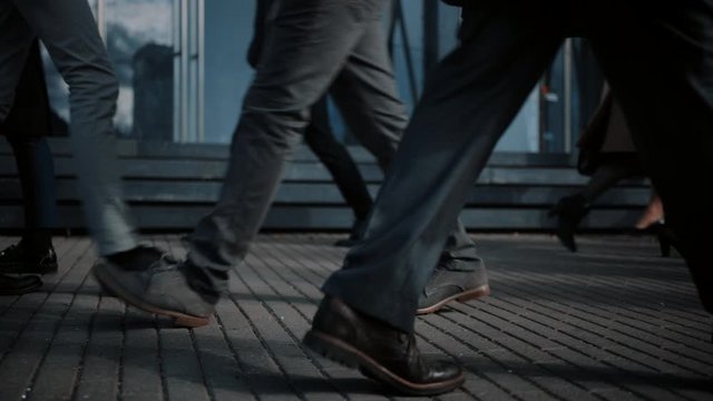 Close Up Leg Shot of a Business People Commuting to the Office on Foot. Managers and Businessmen Walk on a Crowded Pedestrian Street. People Dressed Smart. Cold Light.