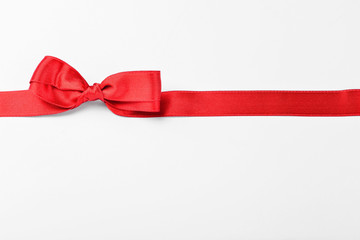 Beautiful red ribbon and bow on white background