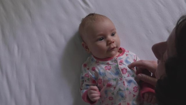 Newborn Baby Laughing Ecstatically Playing with Mom