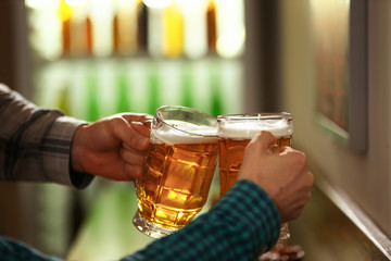 Friends drinking fresh beer in pub