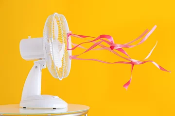 Foto op Plexiglas Electric fan with fluttering ribbons on color background © Pixel-Shot