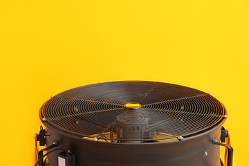 Electric fan on color background