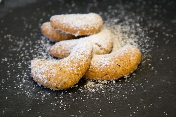 Five sugar coated cookies on a black stone