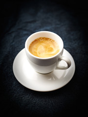 Cup of coffee on dark background. Copy space. 