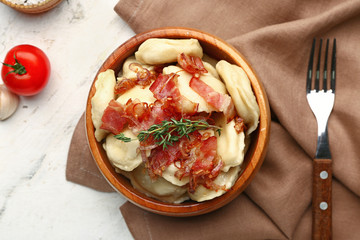 Bowl with tasty dumplings on table