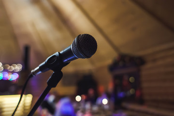Close-up microphone on a stand in the concert hall or conference room, preparation for performance, concert.