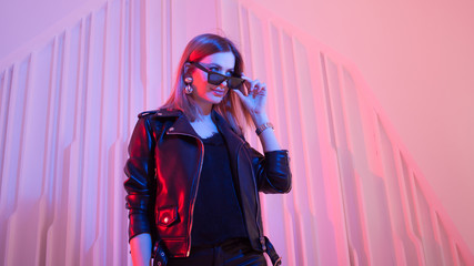 Beautiful girl dancing in retro wave on the neon light