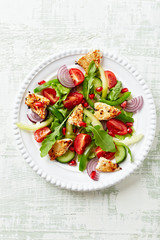 Healthy Salad with Pomegranate seeds, Chicken Briest, Green Pepper and fresh Basil. Bright wooden background. Top view. Copy space.