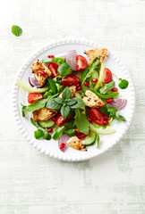 Healthy Salad with Pomegranate seeds, Chicken Briest, Green Pepper and fresh Basil. Bright wooden background. Top view. Copy space. 