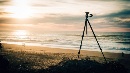 A tripod at a Californian beach during golden hour 