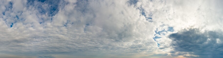 Fantastic clouds against blue sky, panorama