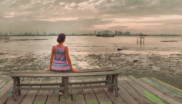 Tourist sitting at Yeoh jetty, Penang, Malaysia. Panorama