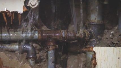 Leaking water from broken kitchen sink pipes