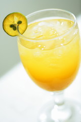 glass of juice with lemon slice of orange