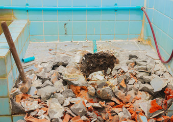repair toilet old bathroom interior house and with Large steel hammer