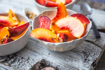 Freshly cut peaches in a white bowl