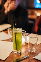 Close up of a green cocktail on a table