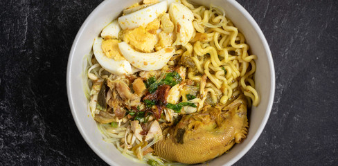 soto ayam is traditional food from indonesia, served with chicken, noodles, egg, sambal and fried onions