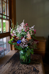 Fototapeta na wymiar bouquet of wild flowers by a window