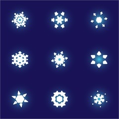 Kit of isolated  silhouettes of snowflakes on blue background.