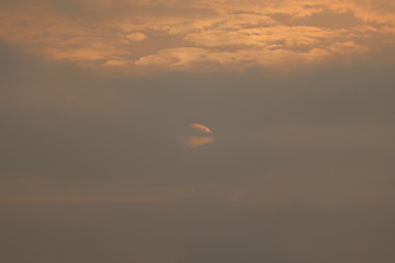 MORNING SUN SHINING BEHIND THE CLOUDS