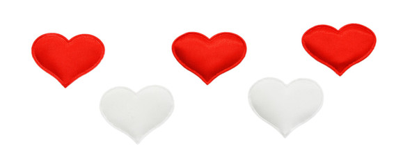 Red and white fabric hearts on an isolated background. Theme for Valentine's Day and holidays