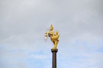 Fototapeta na wymiar Golden bird lantern on the top of pole 