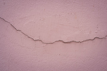 Fototapeta premium Dirty pink concrete wall background. Broken concrete wall background.