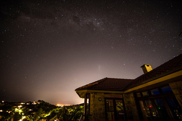 Stars at night above an ocean view house, Sydney, Australia