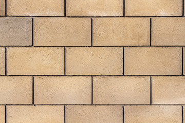A fence around the territory of a private house made of concrete blocks.