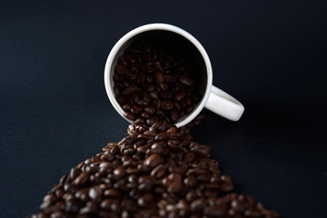 A Cup of coffee among coffee beans