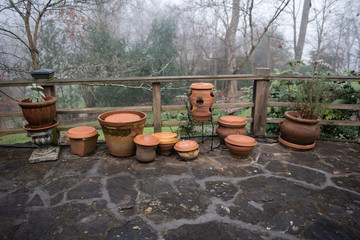 Clay pots on a stone patio - obrazy, fototapety, plakaty