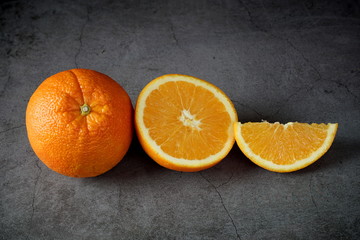 Ripe oranges on a dark gray background