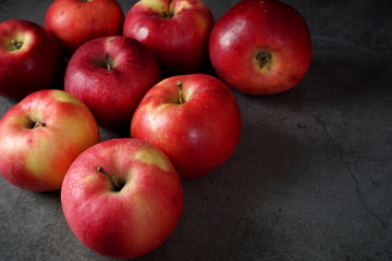 Red apples on a dark background. Selective focus