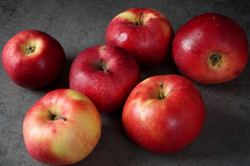 Red apples on a dark background. Selective focus