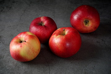 Red apples on a dark background. Selective focus