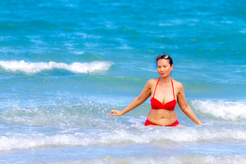 Woman with red bikini happy water on beach  Ban Krut